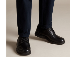 A man is wearing these shoes with a pair of jeans, but these could be paired with dress slacks as well.